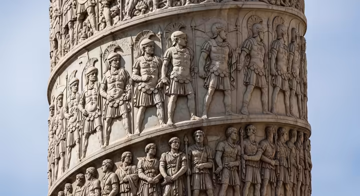 A detailed section of Trajan's Column in Rome, showing Roman soldiers in a narrative relief.