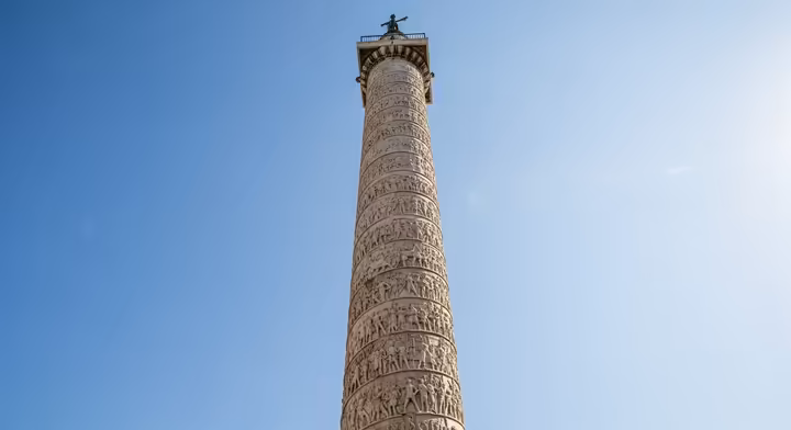 A view of the full Trajan's Column in Rome, emphasizing its height and the spiraling narrative relief.